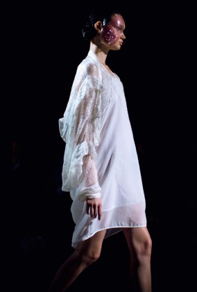 Fashion Artist Danny Roberts Photo of the profile of a model walking in a white Anrealage dress with a bubble mask in the Collection from Tokyo Fashion Week 2012